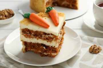 Piece of delicious homemade carrot cake on white table, closeup