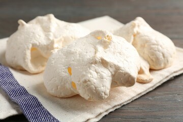 Delicious homemade meringue cookies on wooden table, closeup