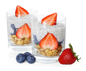 Delicious dessert with chia seeds, yogurt, granola, strawberries and blueberries in glasses isolated on white. Superfood