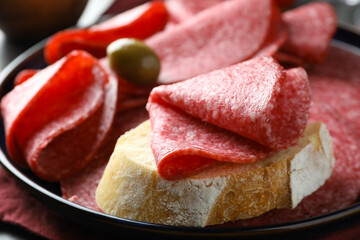 Sandwich with delicious sausage served on table, closeup