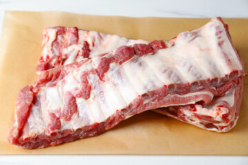Raw pork ribs on white table, closeup