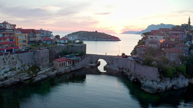 The drone flying over the historical stone bridge in Amasra reveals the fascinating beauty of the region. The colorful Amasra houses and Boztepe Island opposite are magnificent.
