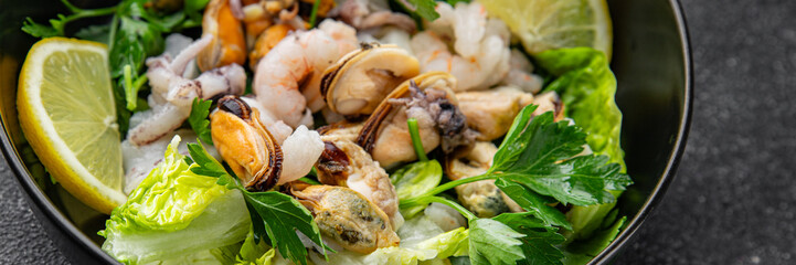 Seafood salad fruit de mer shrimp, mussels, squid, rapawn, prawn, green mixed leaf dish fresh food background on the table rustic food top view copy space keto paleo diet vegetarian pescetarian