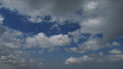 Aerial view of Glan Gwan, Caernarfon, capturing distant remnants of dark cloudscape. This stunning bird's-eye perspective showcases the lush green countryside and charming caravan park.