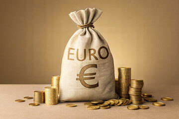 A large canvas money bag filled with euros, nestled among stacks and piles of golden Euro coins.