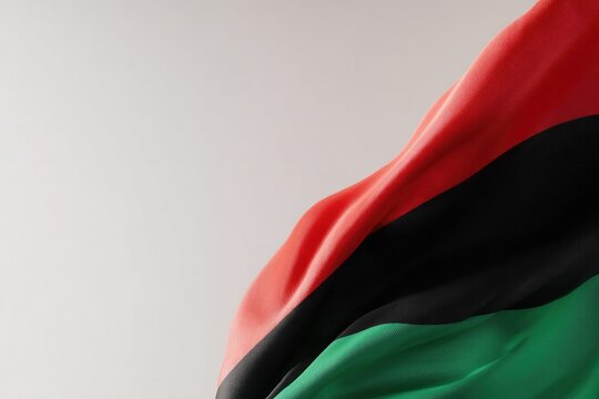 elegant composition highlighting juneteenth symbols simple red black and green flag fluttering gently against clear