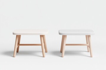 Fototapeta premium Two small, minimalist wooden stools with light-colored seats stand against a white background.
