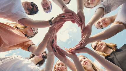 Students joining hands in a circle, representing teamwork, camaraderie, and solidarity