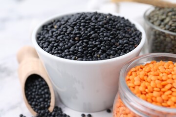 Different types of lentils on white table, closeup