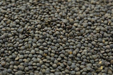 Raw green lentils as background, closeup view