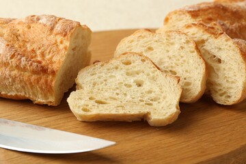 Slices of fresh bread on wooden board, closeup