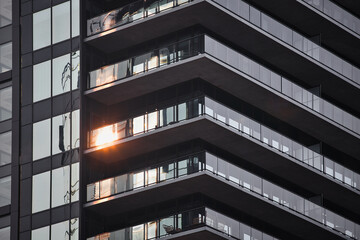 Fototapeta premium Close-up of a modern balcony with sunlight reflecting in the glass. Residential building in Halifax, Nova Scotia, Canada