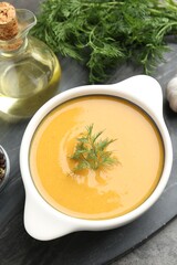 Delicious lentil cream soup with dill served on grey table, above view