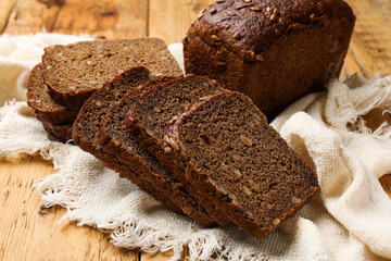 Pieces of fresh bread on wooden table, closeup