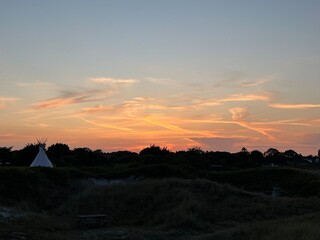 sunset over the tent and dunes