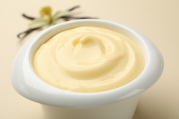 Tasty vanilla pudding on beige background, closeup