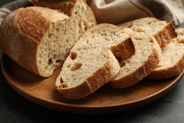 Pieces of fresh bread on black table, closeup