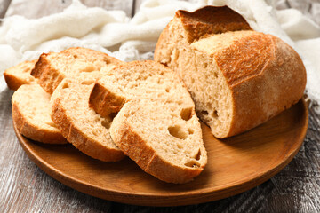 Pieces of fresh bread on wooden table, closeup