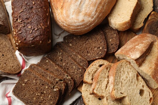Different types of fresh bread on table, flat lay
