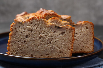 Cut banana bread with nuts on table, closeup