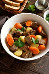 Beef meat stewed with potatoes, carrots and spices