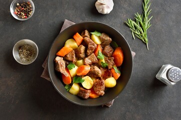 Beef stew with potatoes, carrots and greens