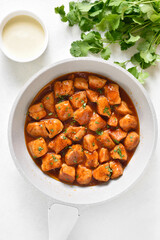 Sweet and spicy chicken bites with sauce in skillet