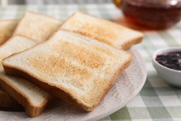 Tasty crispy toasted bread slices on table, closeup