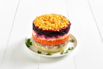 Layered vegetable salad with herring and boiled vegetables
