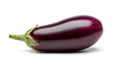 A single shiny purple eggplant with green stem lying on a white surface in studio lighting