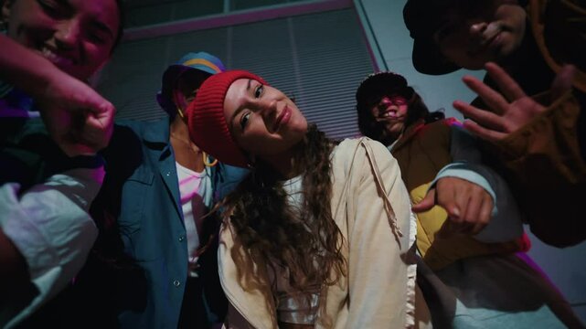 Dancing young people breakdancing in street hip hop dancer practicing dance routine performing freestyle moves in city at night. Urban style friends rap music