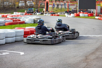 Exciting kart racing competition unfolds on a vibrant outdoor track in springtime