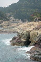 Rock Cave in the Crevice of the Cliff with Waves of Sea