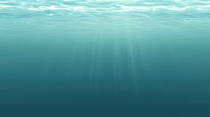 Obraz premium Underwater view of sunlight penetrating the ocean depths.