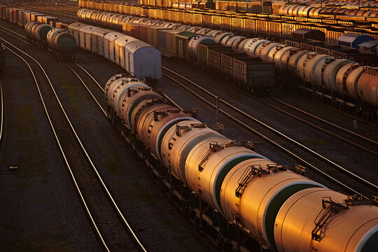 Close-up of wagons and tanks on a railway in the sunset light