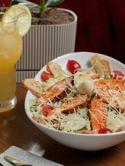 Chicken caesar salad plate on table