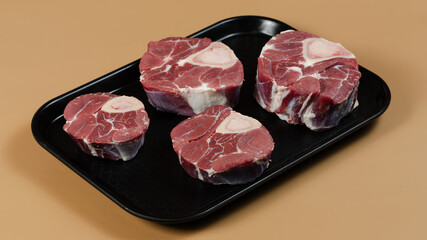 Raw meat on black tray
