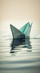 Elegant origami boat crafted from teal and white paper floating on calm water with gentle ripples under soft natural light, minimalist nautical themed scene