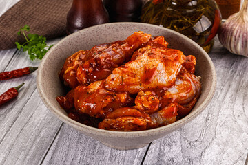 Raw marinated buffalo chicken wings