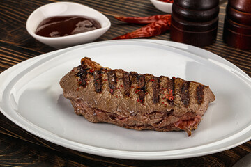 Grilled beef striploin steak with sauce