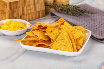 Corn nachos chips with cheese dip
