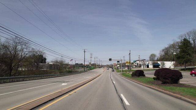 Pittsburgh, Pennsylvania  United States - April 20 2025: Car point of view of shopping centers, businesses, and mainstream chain restaurants on Route 8 in the north hills area in western PA