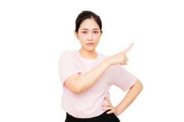 A young woman in a pink shirt points confidently with a serious expression, showcasing assertiveness and focus.