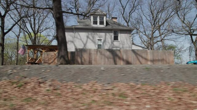 Moving past Pittsburgh, PA greater area suburbs and neighborhood homes in western Pennsylvania in warm, sunny spring weather in April of residential areas in North Hills suburban roads and houses