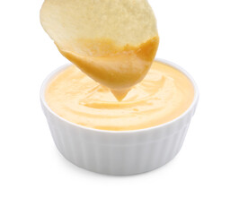 Dipping potato chip into tasty cheese sauce on white background, closeup