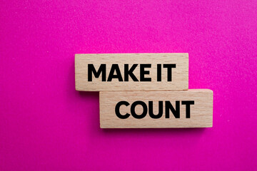 Make it count message written on wooden blocks on pink background. Conceptual make it count symbol....