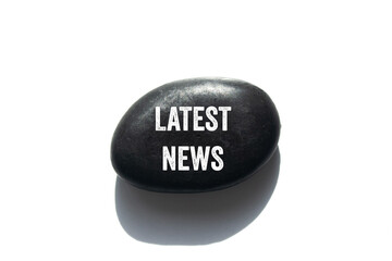 Latest news message written on black stone on white background. Conceptual latest news symbol. Copy...