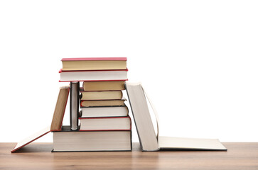 Many old books on wooden table against white background