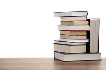 Stack of old books on wooden table against white background