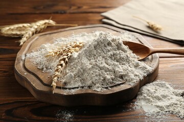 Pile of flour and spikes on wooden table, closeup